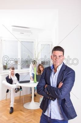 angry business man in front of colleagues working as team