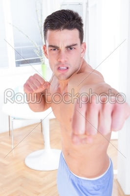 angry man hitting into camera with clenched fist