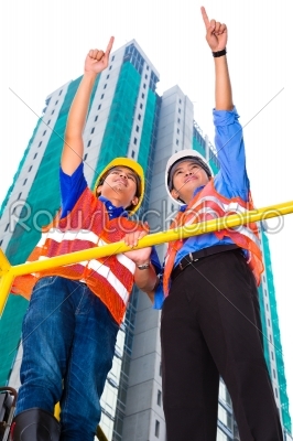 Asian architect and supervisor on construction site