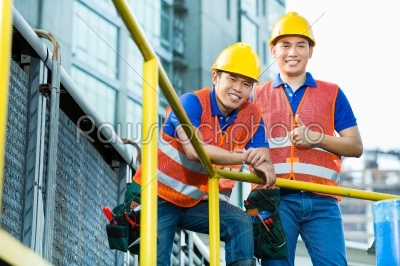 Asian Indonesian construction workers on building site