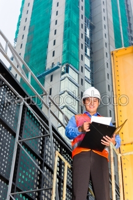 Asian worker or supervisor on building site  