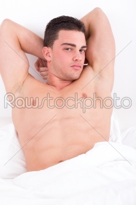 attractive muscular man lying in bed