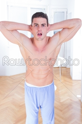 Attractive young muscle man showing athletic torso and biceps
