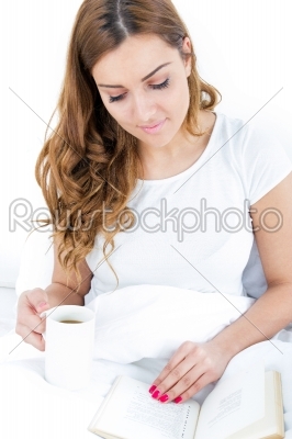 beautiful happy woman reading book and drinking coffee