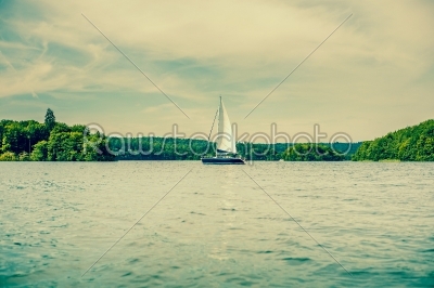 Boat with sail on a lake