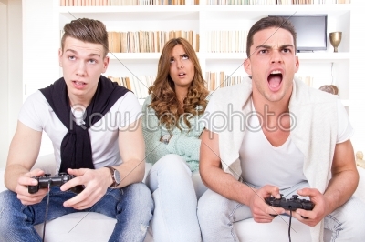 bored women between two men with joystick