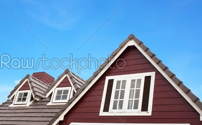 Brown tile roof in garden agains