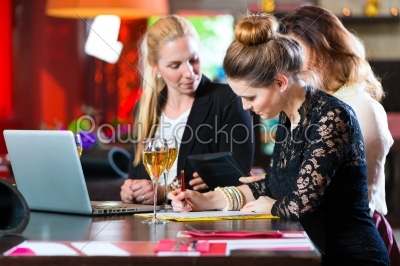 Business Colleagues working with documents in a cafe