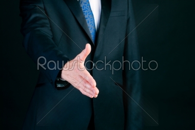 Business man in suit offering handshake 