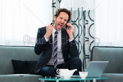 businessman in hotel is on the phone