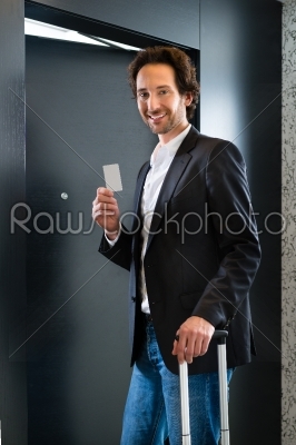 Businessman with key card for room door in hotel