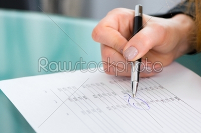 Businesswoman marking data on a Business plan