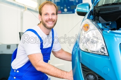 Car mechanic and auto in service workshop