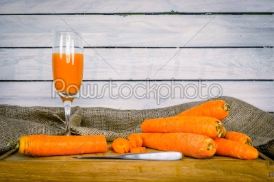 Carrot juice on a wooden board