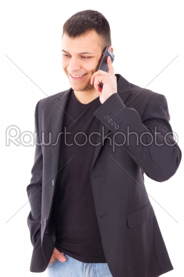 casual man in a suit talking over mobile and smiling