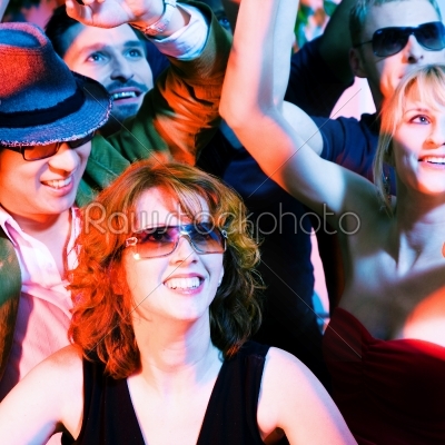 Cheering crowd in disco club