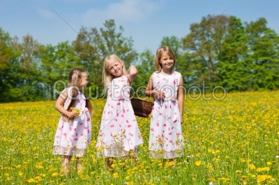 Children on Easter egg hunt with baskets