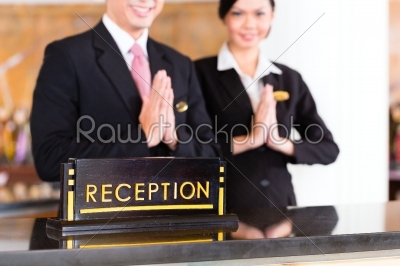 Chinese Asian reception team at hotel front desk