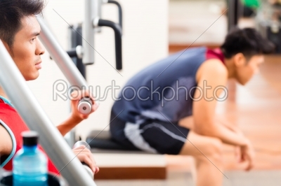 Chinese sport men training in fitness gym