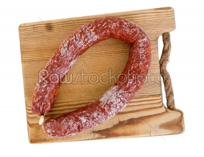 Chorizo sausage and wooden board isolated as Cut