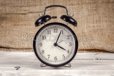 Classic alarm clock on a wooden table