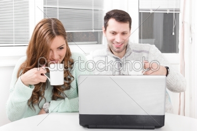 Close up beautiful couple working on laptop at home