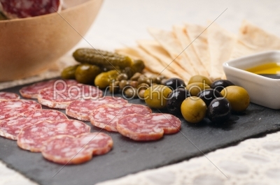 cold cut platter with pita bread and pickles