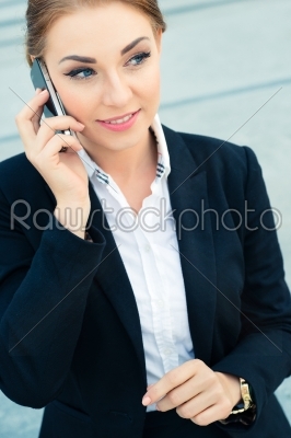 Confident businesswoman talking on business phone 