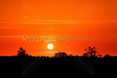 Countryside sunset in dark red color
