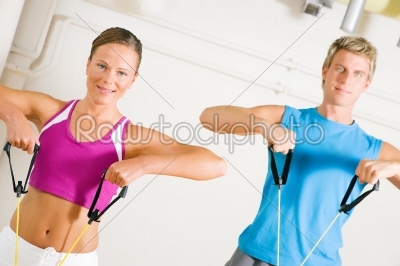 Couple doing Tube Training in gym