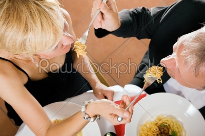Couple eating pasta for dinner