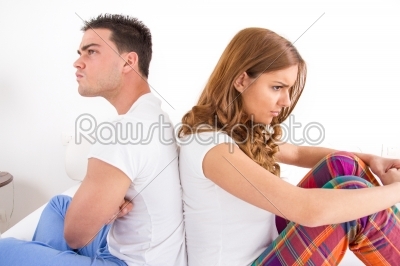 couple having an argument while they sitting on bed