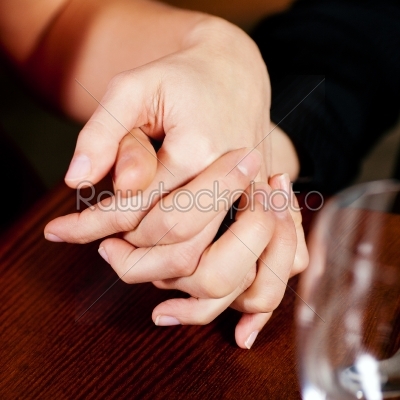 Couple holding hands on a table