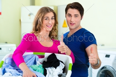 couple in a coin laundry washing