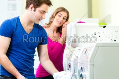 couple in a coin laundry washing