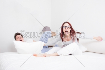 couple in pillow fight with face expression