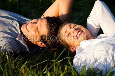 Couple lying on meadow in the sunshine
