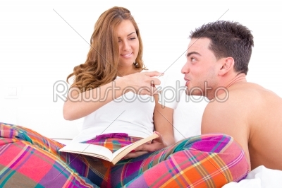 couple resting in bed having coffee in the morning