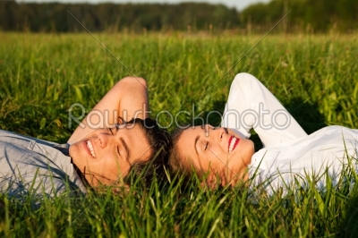 Couple sleeping on meadow in the sunshine