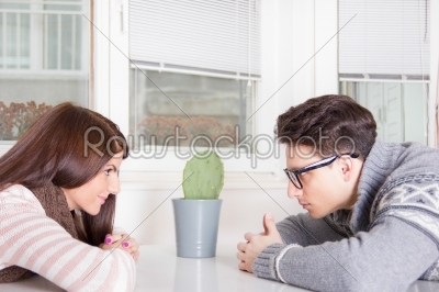 couple staring at each other across the table