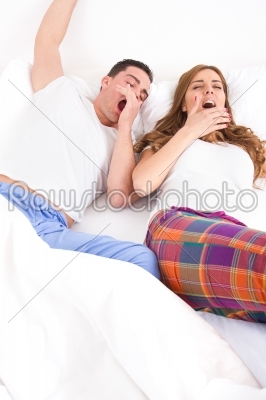 couple waking up in the bedroom and stretches
