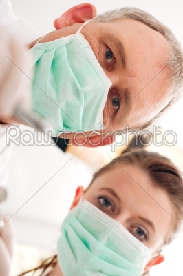 Dentist, Assistant and drill in a treatment