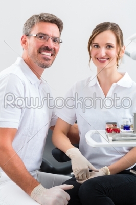 Dentists in their surgery or office with dental tools