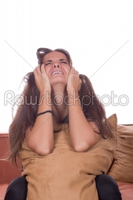 Disappointed girl crying with pillow