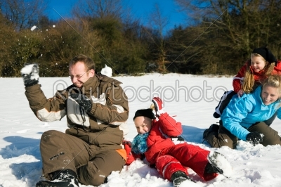 Family having a snowball fight