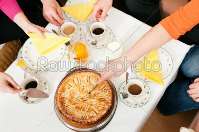 Family having coffee and cake together