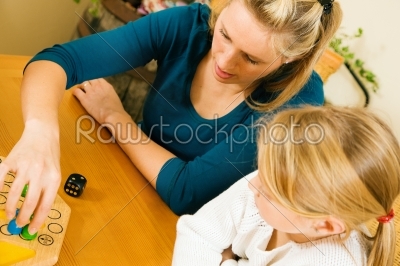 Family is playing ludo together
