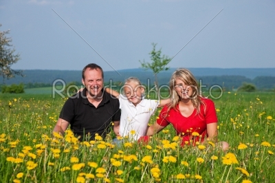Family on meadow in spring