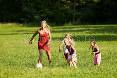 Family playing soccer