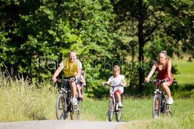 Family riding the bicycles together